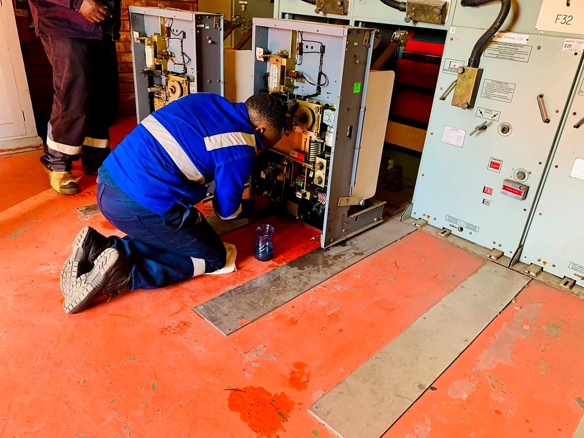 Technician servicing a withdrawn circuit breaker